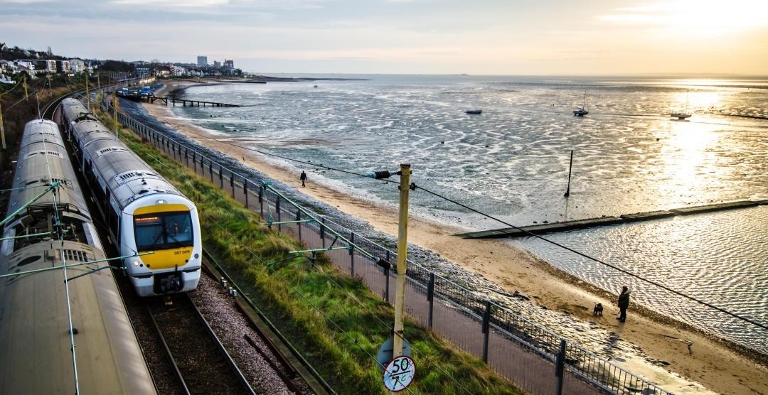 Train running along the Southend coastline at sunset